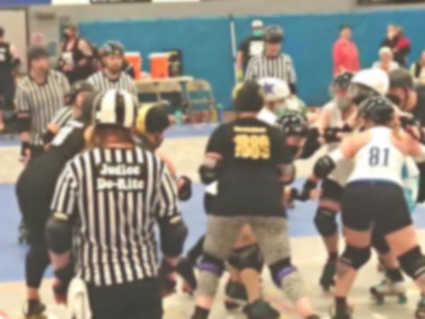 Roller derby skaters in game action
