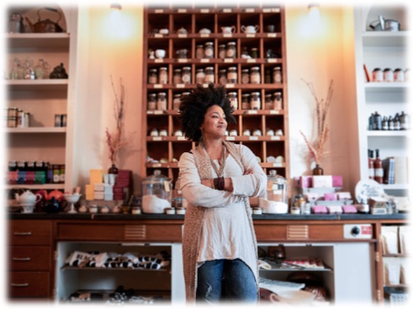 A confident business owner standing in front of a counter.