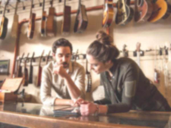Two people shopping for guitars