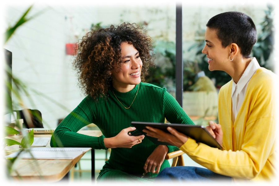 A manager and employee planning the future with a tablet computer.